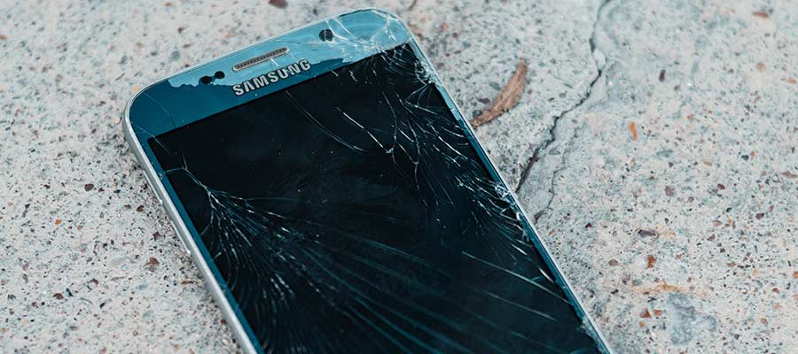 A cell phone with a cracked screen.