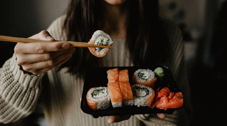 woman eating sushi simple plate