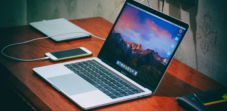 macbook pro laptop on desktop designer