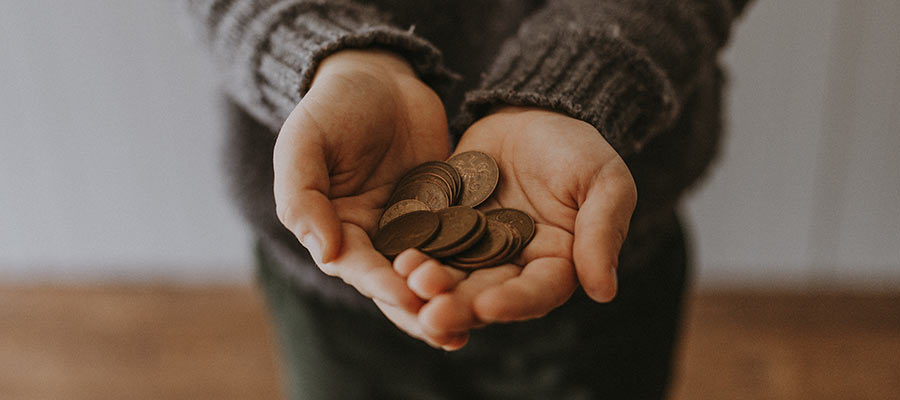 A person holding coins.