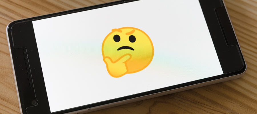 A "thinking" emoji displayed on a phone.