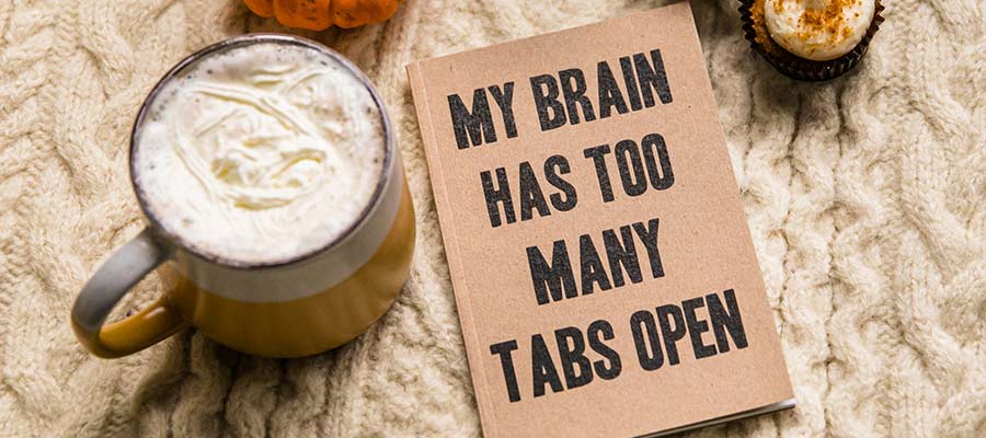 A sign that reads, "My brain has too many tabs open".