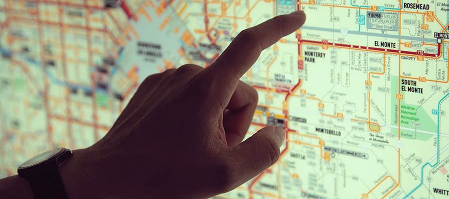 A person pointing to a map.