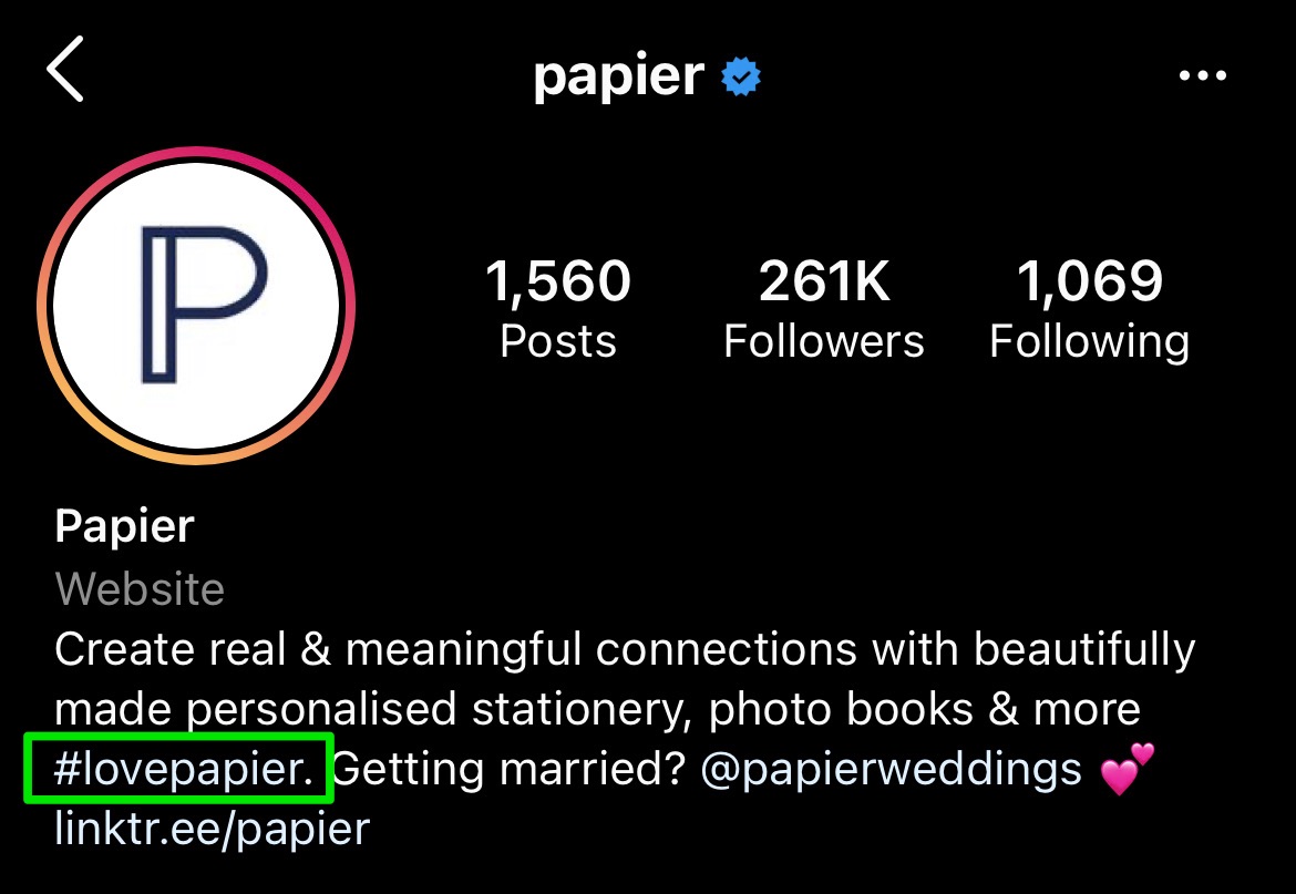 papier bio showing their branded hashtag mention