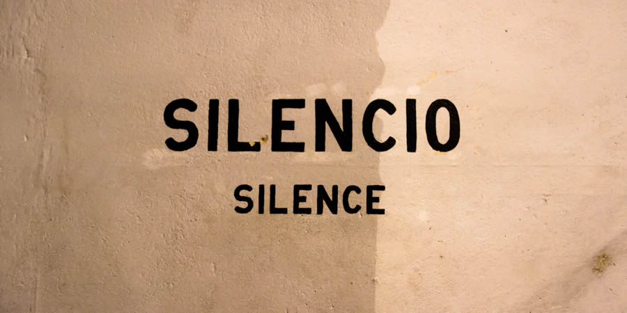 silence silencio painted wall sign