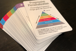 A deck of personalization brainstorming cards (the size of playing cards) against a black background.