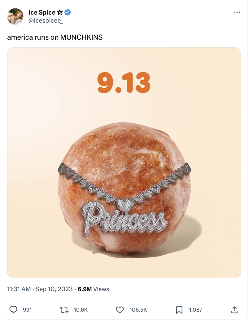 A Post on X (formerly known as Twitter) from rapper Ice Spice showing a Dunkin' Munchkins® donut hole wearing an elaborate diamond "Princess" chain. The caption reads, "American runs on Munchkins."