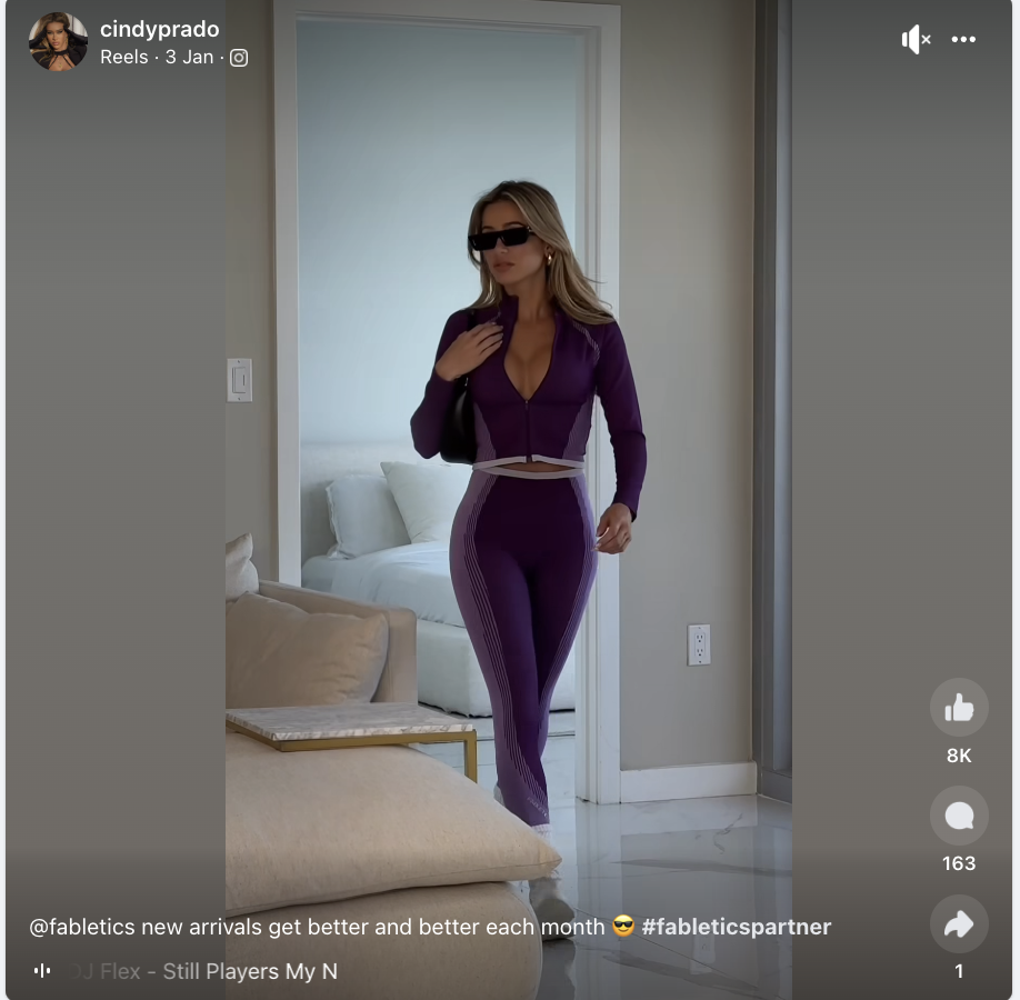 A Facebook post showing the user in a purple Fabletics suit and sunglasses and a caption that includes the hashtag #fableticspartner