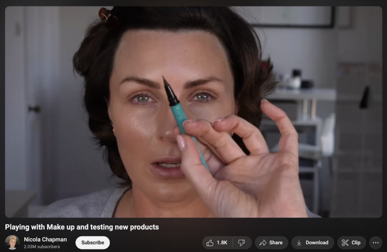 Nicola Chapman holding a brow pencil in a YouTube video