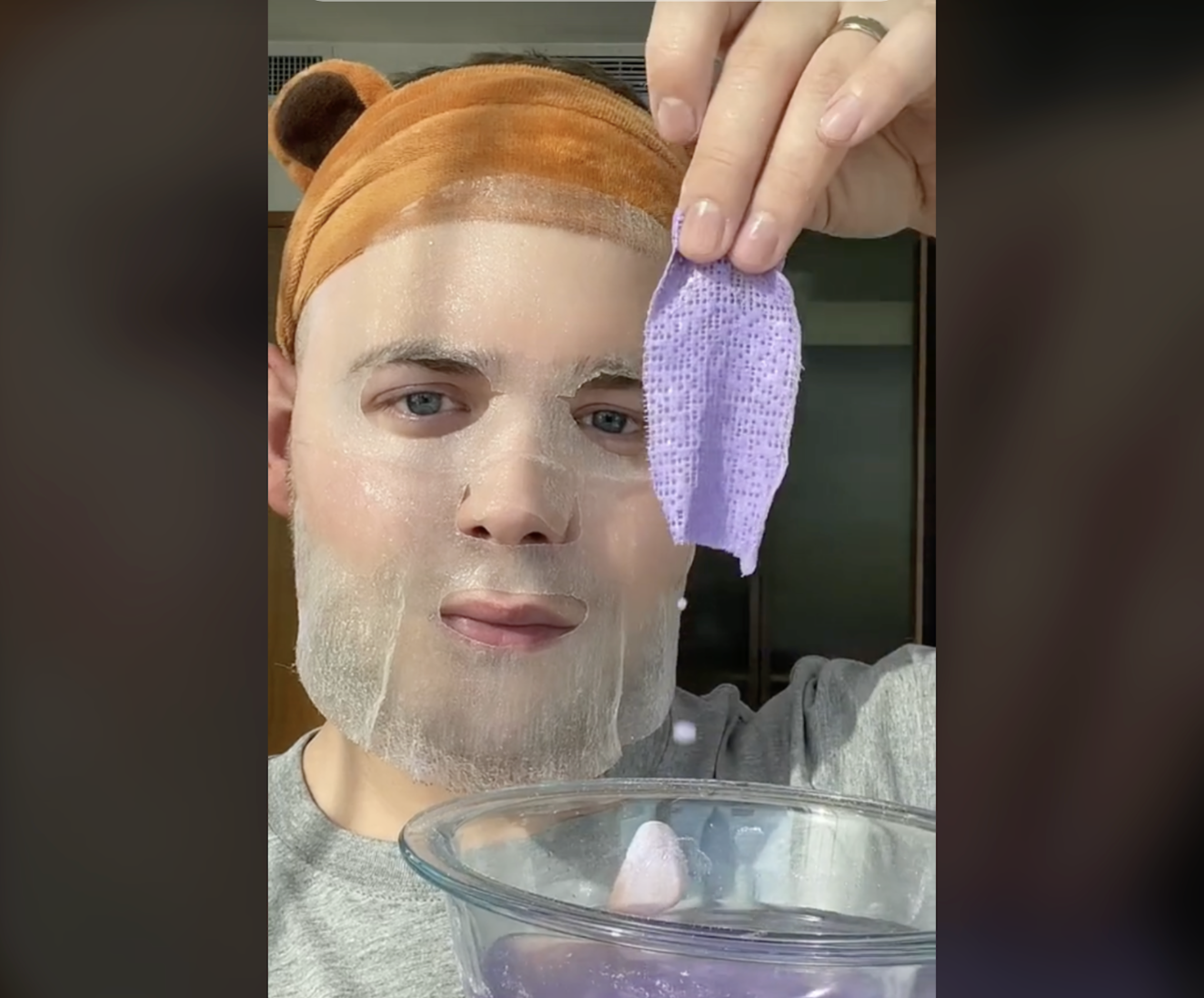 Jake Jamie applying a facemask in a TikTok video. 