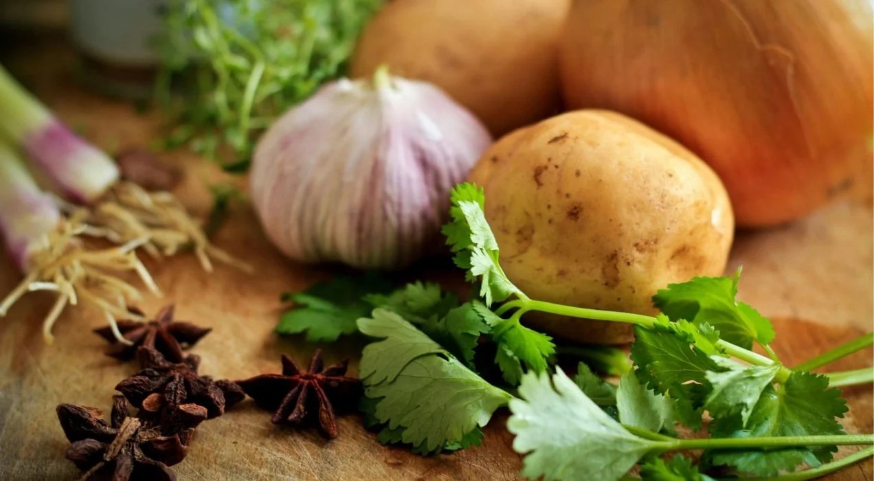 garlic, potatoes, and herbs on a cutting board