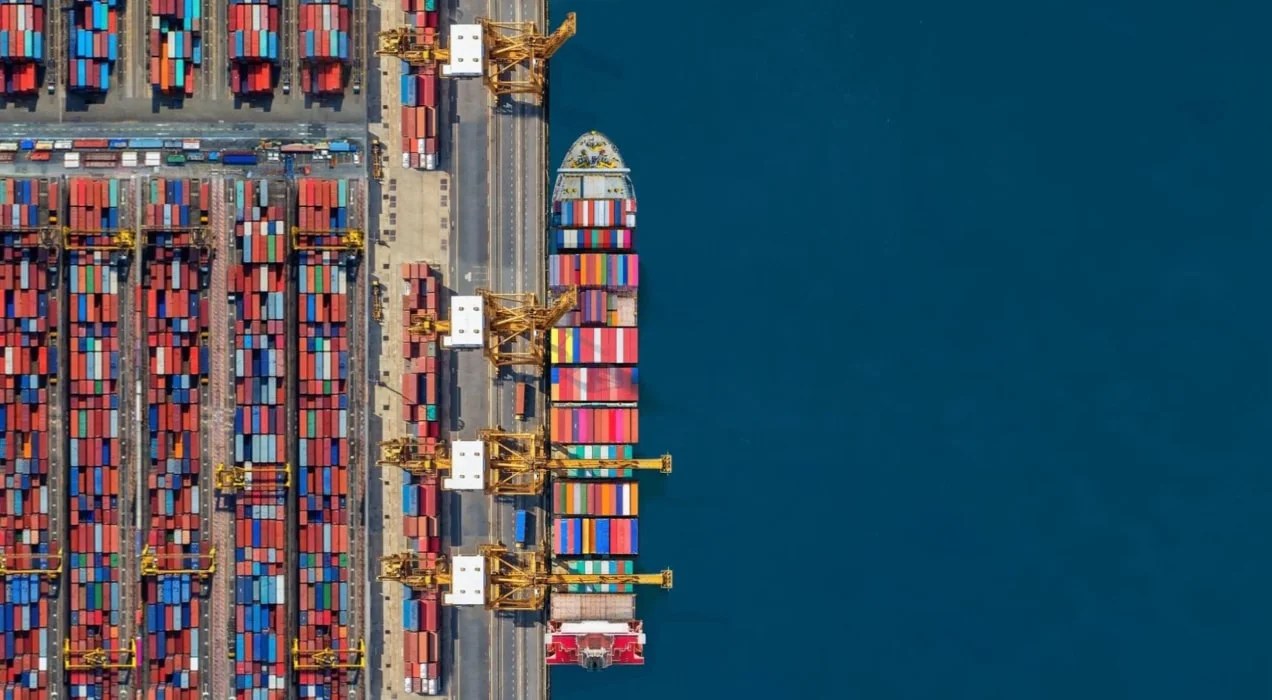 an aerial view of a ship full of containers on the ocean