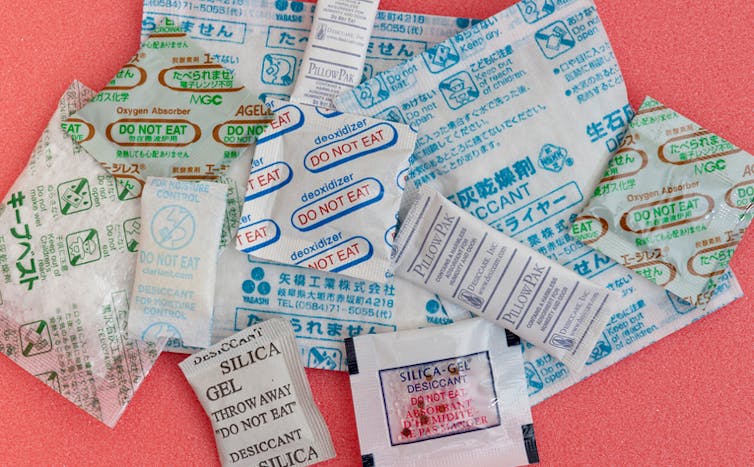 A pile of various sachets and sheets found inside products.