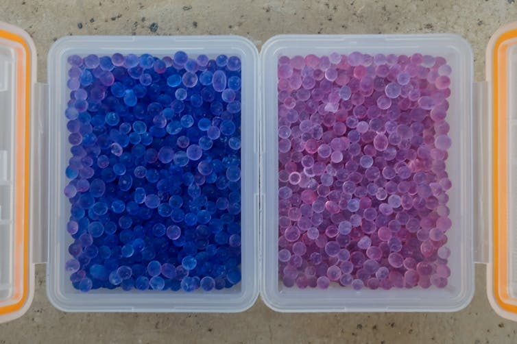 Two plastic containers, one with blue translucent beads, one with pink.