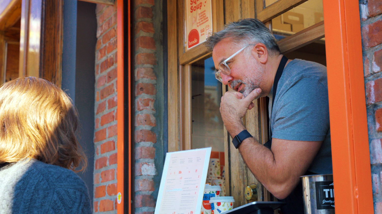 Chef Marco taking a customer's order from the Brodo storefront in Manhattan