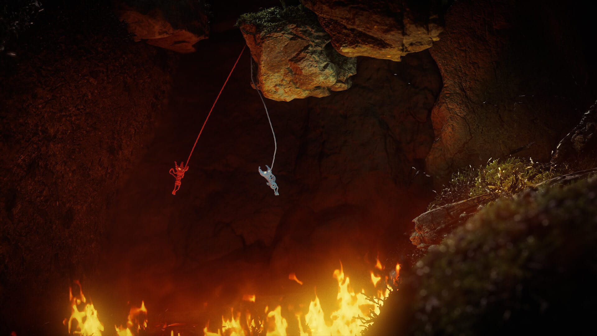 two yarn (yarnys) creatures are seen swinging together to cross a fiery pit, they are attached to a rock above