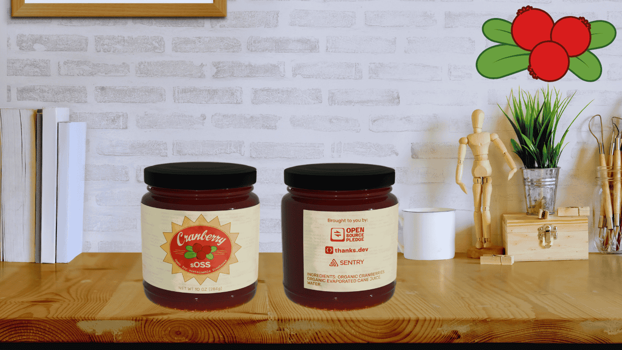 there is a wooden desk here with two jars of cranberry soss sitting on them, on the left is the front view of the jar with the logo, on the right is the rear view of the jar with some important info on who made this possible and the ingredients of the jar.