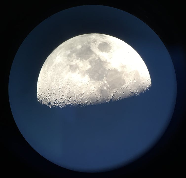 A photo of the Moon taken with a mobile phone and telescope.