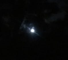 An image of the Moon that's just a fuzzy white blob.
